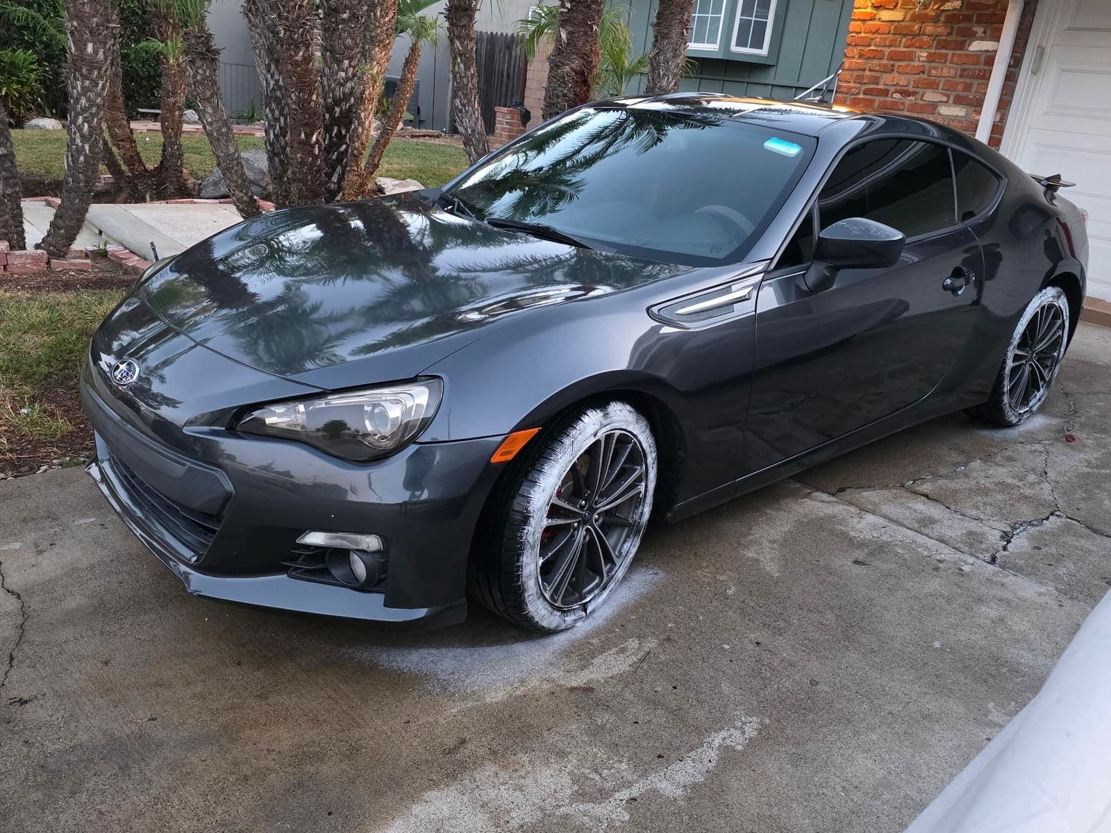Dark gray Subaru BRZ front three-quarter with glossy paint mid-detail