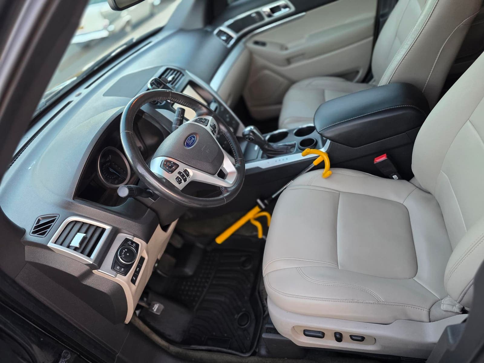 Ford Explorer driver-side interior with cream leather, freshly detailed