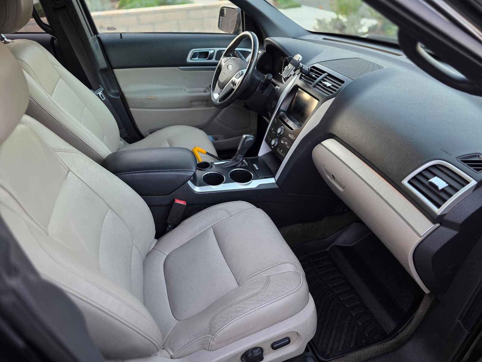 Ford Explorer passenger-side interior, cream leather and console after detailing